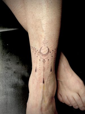 Hand-poked dotwork moon and ornamental pattern tattoo on shin by Indigo Forever Tattoos.