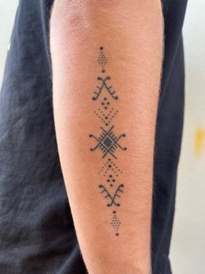 Unique hand-poked ornamental pattern tattoo on forearm by Indigo Forever Tattoos, perfect for a stylish and intricate look.
