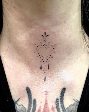 Experience a unique hand-poked design by Indigo Forever Tattoos featuring a beautiful heart motif intertwined with intricate patterns on your neck.