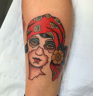 Beautiful traditional style tattoo featuring a woman and a flower, expertly done by Andrea Furci on the lower leg.