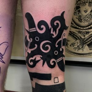 Get a unique blackwork tribal pattern tattoo expertly done by Andrea Furci on your knee for a bold and striking look.