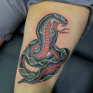 Experience the intricate beauty of a Japanese snake tattoo on your upper leg, expertly crafted by the talented artist Andrea Furci.