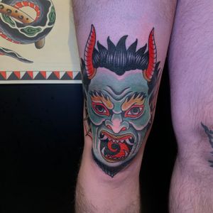 Unique Japanese devil tattoo by artist Andrea Furci, perfect for knee placement. Bold and striking design.