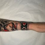 Explore the beauty of blooms with this stunning traditional style forearm tattoo by Andrea Furci.