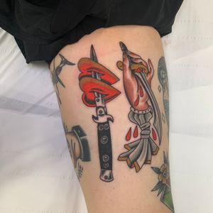 Check out this captivating upper arm tattoo featuring a traditional style heart and knife design by Andrea Furci.