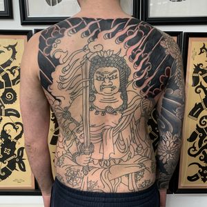 Experience the power and beauty of Japanese art with this stunning sword and god tattoo on your back, expertly crafted by Andrea Furci.