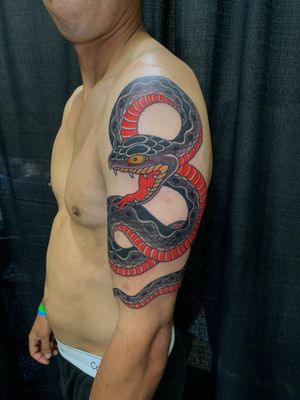 Traditional Japanese snake tattoo on upper arm by the talented artist Andrea Furci. Bold and dynamic design.