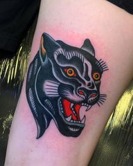 Get inked with a fierce traditional panther design by renowned artist Andrea Furci. Stand out with this timeless piece on your arm.
