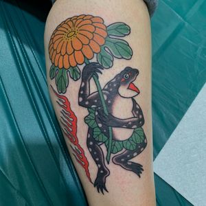 Beautiful lower leg tattoo featuring a Japanese style frog and flower motif, expertly done by Andrea Furci.