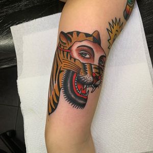 Get a fierce and powerful traditional tattoo featuring a leopard and a woman, expertly done by Andrea Furci on your arm.
