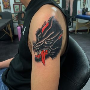 Adorn your upper arm with a traditional style wolf tattoo designed by the talented artist Andrea Furci.