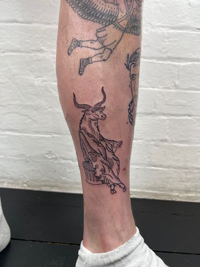 Get a majestic goat with baphomet horns inked on your lower leg by Jack Henry Tattoo for a unique and stylish look.