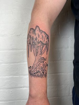 Unique black and gray tattoo by Jack Henry featuring a tree and a smoking frog motif, delicately inked on the forearm.