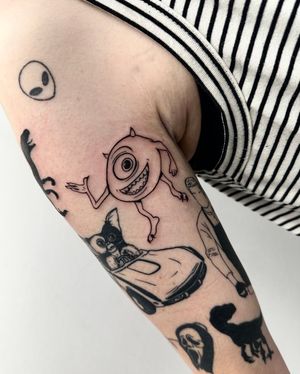 Get inked with this playful anime blackwork piece by tattoo artist Miss Vampira, featuring the iconic character Mike Wazowski from Monsters, Inc.