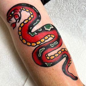 Experience the timeless artistry of Alessandro Lanzafame with this striking traditional snake motif on your forearm.