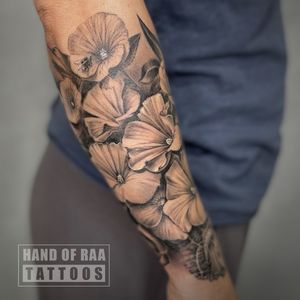 Elegant black and gray flower design by Raa, perfect for showcasing on the forearm.