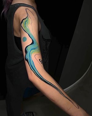 Experience a dreamlike journey with breathtaking watercolor patterns on your sleeve tattoo by the talented artist Artemis.