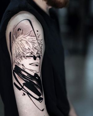 Capture the essence of anime with this blackwork tattoo of a man wearing glasses on your upper arm. By artist Artemis.