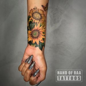Stunning floral design featuring a vibrant sunflower by Raa, perfect for your forearm.