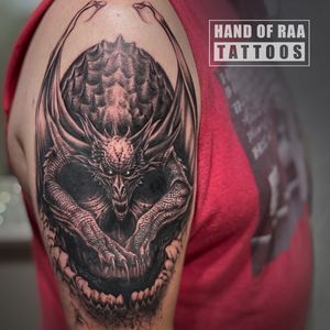 Embrace the dark side with this striking blackwork tattoo featuring a skull and gargoile design by talented artist Raa.
