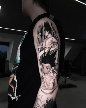 Get an edgy blackwork anime man tattoo on your upper arm by the talented artist Artemis. Stand out with this unique and stylish design.
