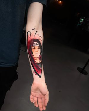 Elevate your style with a stunning anime new school forearm tattoo by Artemis; a bold and vibrant depiction of a man.