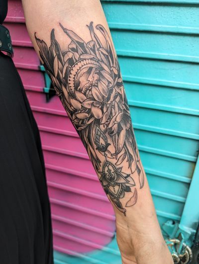 Traditional black and gray tattoo of a beautiful chrysanthemum flower on the forearm, done by the talented artist George Antony.