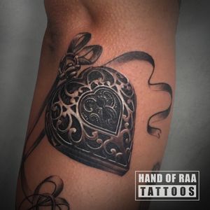 Discover the symbolic connection of heart and key in this stunning black and gray realism tattoo by Raa.
