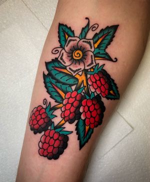 Vibrant floral and fruity design by renowned artist Ryan Goodrum, perfect for a bold statement on your forearm.