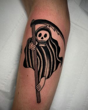 Impressive forearm tattoo by Ryan Goodrum featuring a skull and scythe in bold blackwork style.