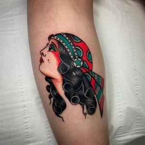 Capture the mystique and beauty of a traditional gipsy woman with this lower leg tattoo by Ryan Goodrum.