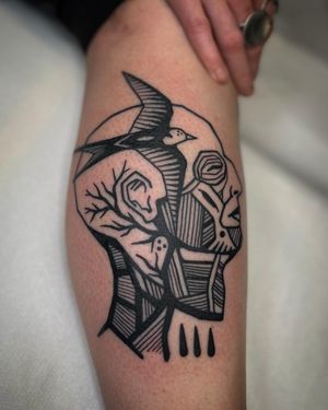 This blackwork illustrative tattoo features a unique blend of swallow and abstract man design, expertly executed by artist Adrimetric.