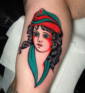 Classic and bold traditional style tattoo of a woman, perfectly placed on the upper arm by talented artist Ryan Goodrum.