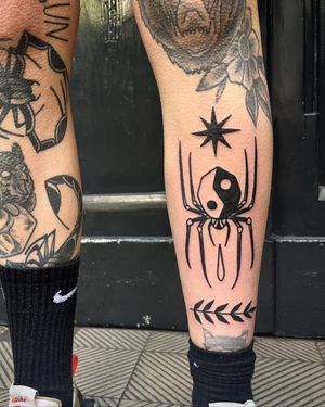 Get a unique blackwork tattoo featuring a star and a spider, done by the talented artist Adrimetric. Perfect for those who love dark and illustrative designs.