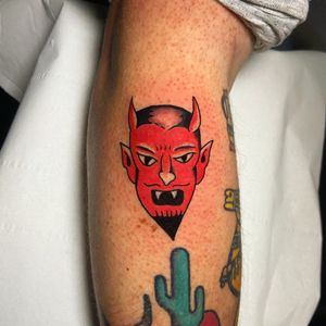 Get inked with a fierce devil motif on your arm by talented artist Ryan Goodrum. Embrace the dark side with this striking traditional tattoo design.