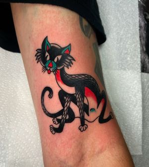 Get a classic traditional cat tattoo on your lower leg by the talented artist Ryan Goodrum.
