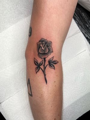 Classic black and gray fine line flower design on arm by talented artist Ryan Goodrum.