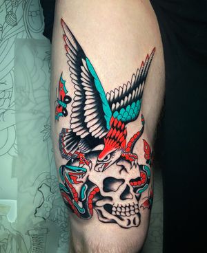Unique upper leg tattoo by Ryan Goodrum featuring a snake, skull and eagle motif in traditional style.