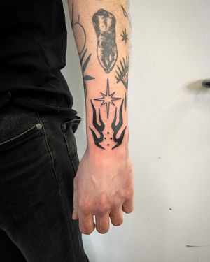 Get a bold and unique look with this illustrative blackwork tattoo of abstract flames by the talented artist Adrimetric.