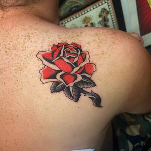 Get a stunning traditional flower tattoo on your upper back by the talented artist, Ryan Goodrum. Embrace the beauty of nature with this elegant design.