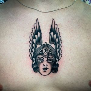 Experience the artistry of Ryan Goodrum with this stunning chest tattoo featuring intricate dotwork wings and a mysterious woman design.