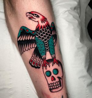 Impressive lower leg tattoo of an eagle and skull in traditional style by Ryan Goodrum.
