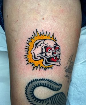 Get a bold traditional skull tattoo on your upper arm by the talented artist Ryan Goodrum for a timeless and edgy look.