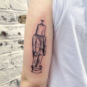 Elegant upper arm tattoo of a man holding a bucket, done in fine line style by Kiky Flore.