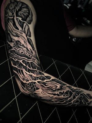 Expertly crafted black & gray dotwork dragon sleeve tattoo by Kike Krebs.