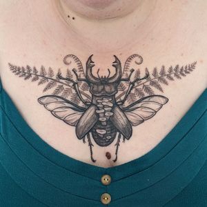 Experience the detailed beauty of blackwork, dotwork, hand_poke, and illustrative styles with this unique beetle tattoo by Alien Ink.