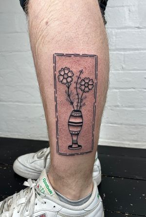 Adorn your lower leg with intricate dotwork and fine line design by Jack Henry Tattoo, featuring beautiful flowers and plants in a vase.