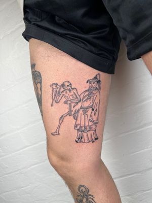Get inked by the talented Jack Henry with a black and gray masterpiece featuring a mystical blend of a skeleton, man, and merlin on your upper leg.