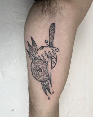 A stunning black and gray fine line tattoo of an orange, knife, and leaves on the upper arm by Jack Henry Tattoo.