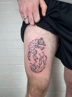 Get a stunning black and gray tattoo of a dog and fox on your upper leg by Jack Henry Tattoo. Perfect for animal lovers seeking detailed artwork.